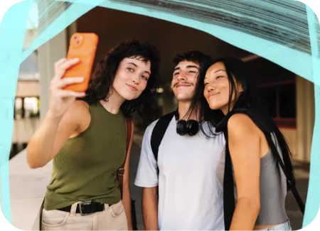 Three students taking a selfie together.