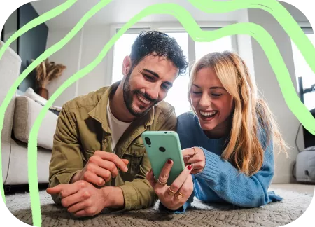 Two young people are watching something on a phone.